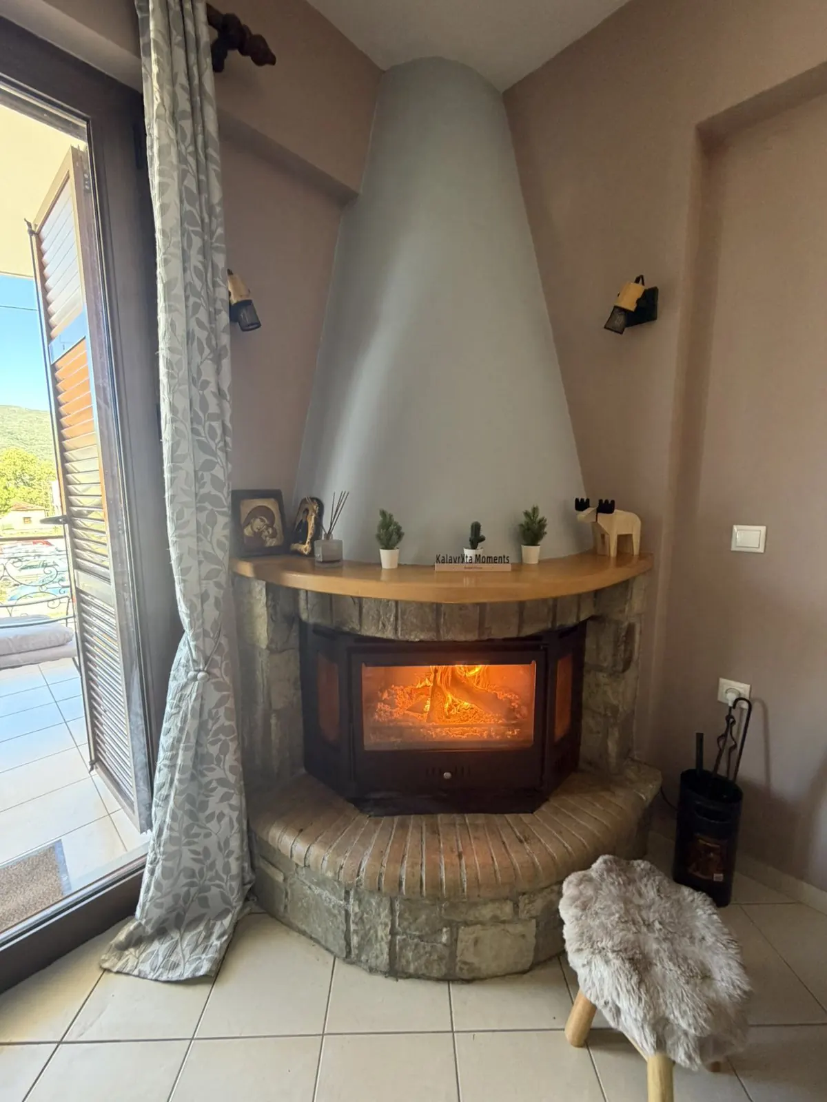 The stone fireplace with the fire lit